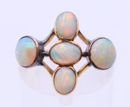 A 9 ct gold five stone opal ring. Ring size N.