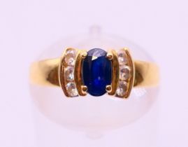 An 18 ct gold, sapphire and diamond ring. Ring size J/K.