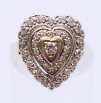 A 14 ct white gold diamond heart ring. Ring size H/I.