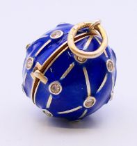 A silver enamel ball locket. 2 cm diameter.