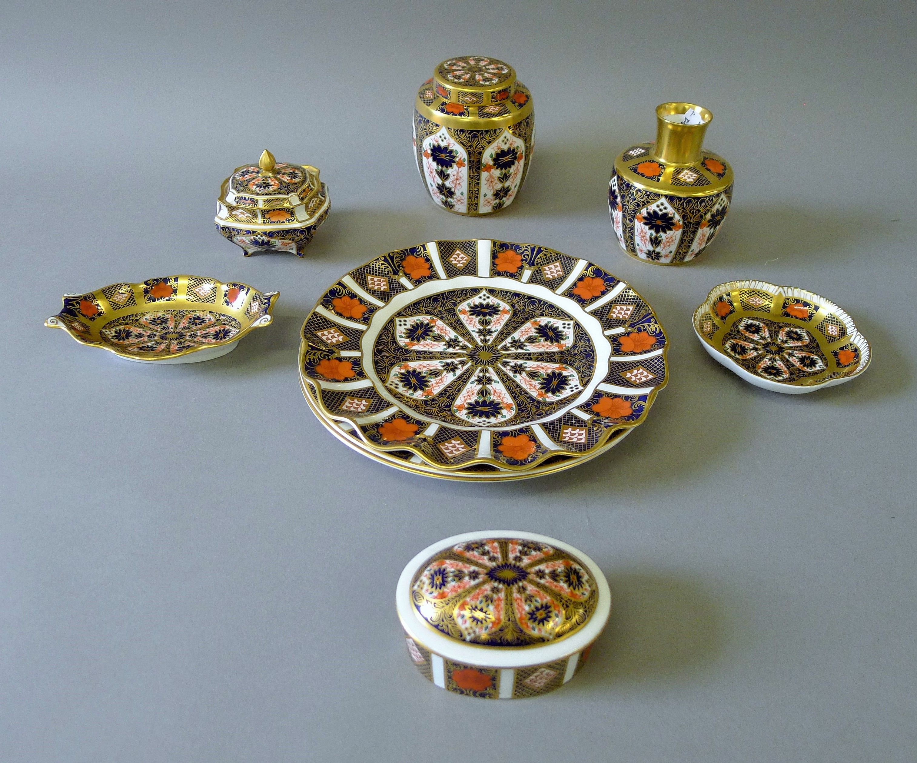 A quantity of Royal Crown Derby, including plates, a vase, a lidded urn etc. The latter 11 cm high.