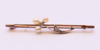 An unmarked gold, diamond and seed pearl bar brooch. 5 cm long.