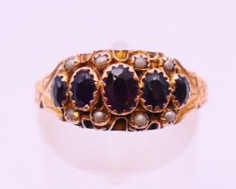 A 9 ct gold, garnet and seed pearl ring, hallmarked for Chester 1907?. Ring size P.