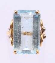 An unmarked gold single stone aquamarine ring. Ring size L, stone 2 cm x 1.25 cm.