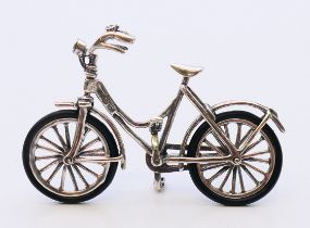 A silver miniature bicycle. 6.5 cm x 4 cm.