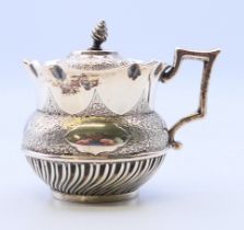 A Victorian silver mustard pot, with associated liner and spoon.