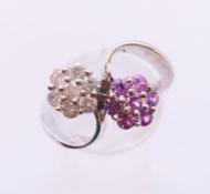 An 18 ct white gold, pink sapphire and diamond double cluster ring. 5.9 grammes. Ring size N/O.