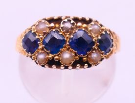 A 15 ct gold, sapphire and seed pearl ring, hallmarked for Birmingham. Ring size J/K.