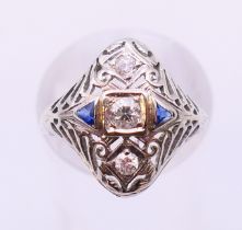 An 18 K white gold, diamond and sapphire ring. Ring size O.