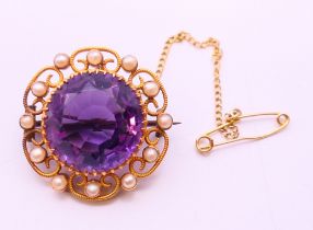 A 15 ct gold, amethyst and seed pearl brooch. 2.5 cm diameter.