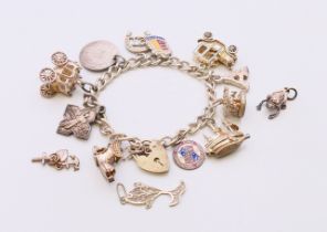 A silver charm bracelet with charms and three loose charms. Bracelet approximately 18 cm long.