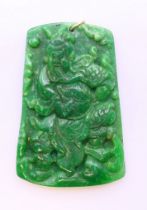 A jade pendant in the form of a deity, with 9 ct gold suspension loop. 6.5 cm x 4.25 cm.