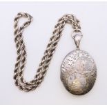 A silver locket with bird and owl motif on a rope twist chain. Locket 5.