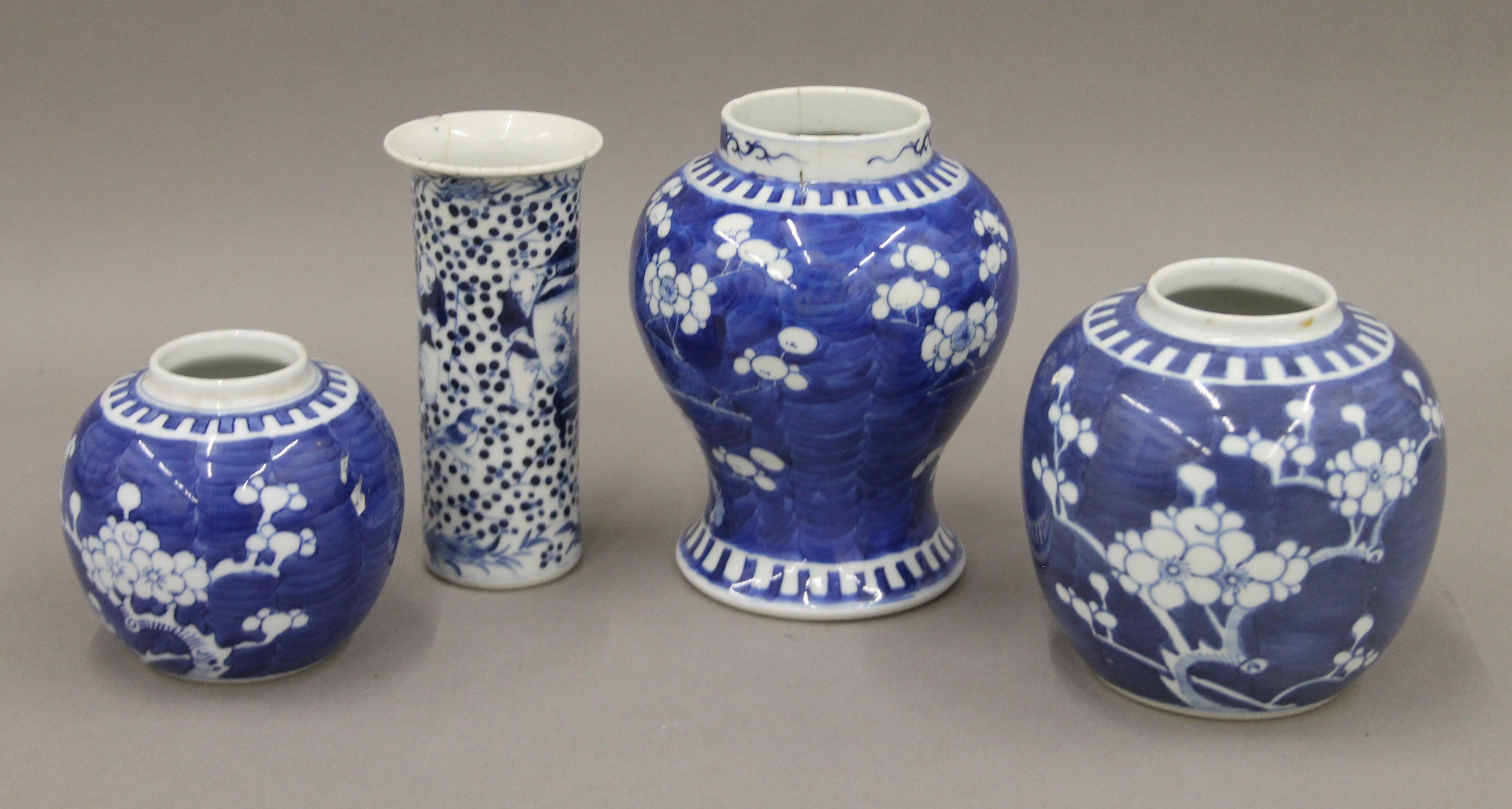 A 19th century Chinese porcelain blue and white prunus vase, two ginger jars and a sleeve vase.