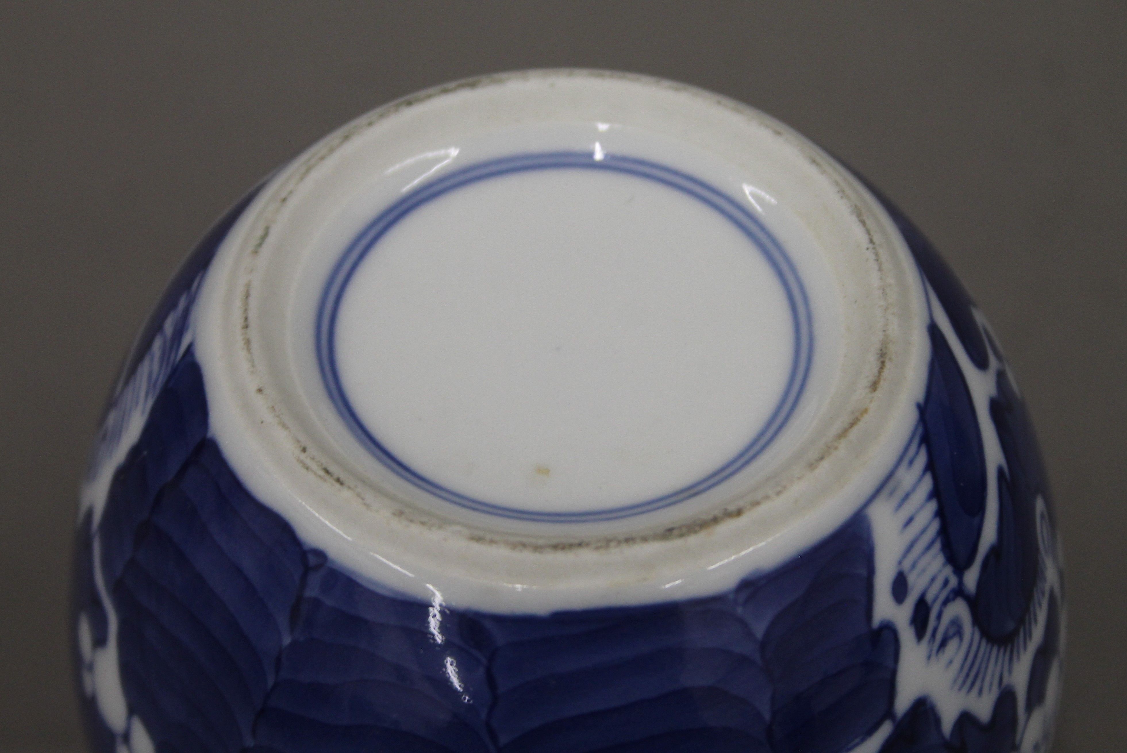 A 19th century Chinese porcelain blue and white prunus vase, two ginger jars and a sleeve vase. - Image 7 of 13