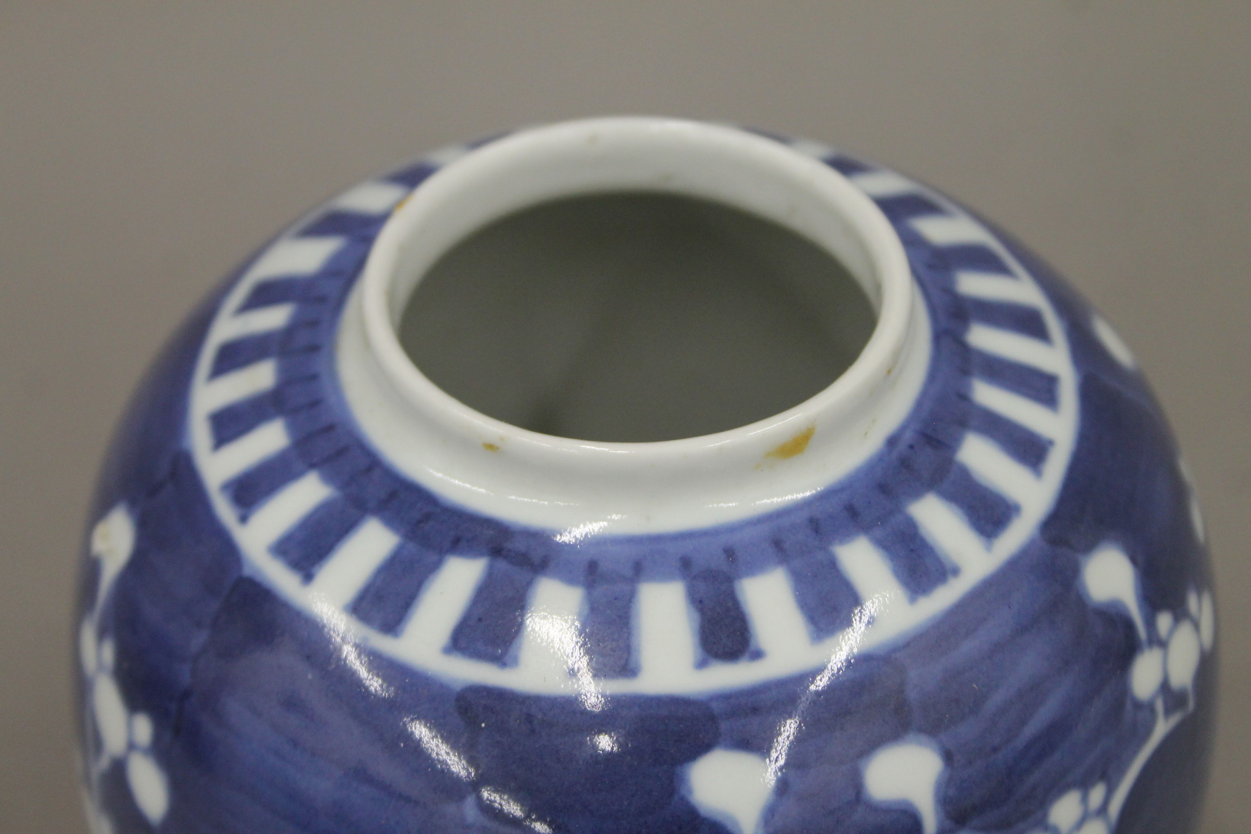 A 19th century Chinese porcelain blue and white prunus vase, two ginger jars and a sleeve vase. - Image 12 of 13
