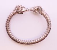 An unmarked silver rams head bracelet. 48.4 grammes.