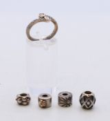 A boxed silver Pandora ring with four silver Pandora charms. Ring size L.