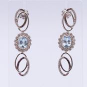 A pair of 18 ct white gold diamond and aquamarine earrings. 4.5 cm high.