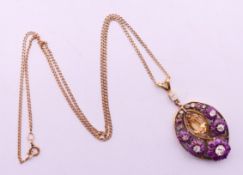 An unmarked gold, ruby, diamond and citrine pendant on a 9 ct gold chain. The pendant 4.5 cm high.