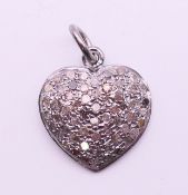 A diamond heart pendant. 1.2 cm high.