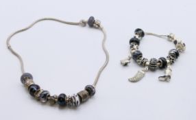 A boxed Pandora necklace and bracelet. The necklace 40 cm long.