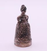 A silver figural thimble and pin cushion. 4.5 cm high.