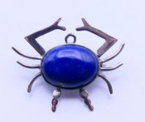 A silver and lapis lazuli crab brooch. 3.5 cm wide.
