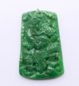 A gold mounted jade pendant. 6.5 cm high.