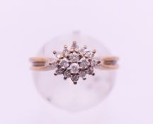 A 9 ct gold and diamond cluster ring. Ring size N/O.