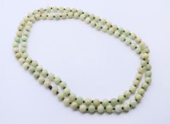 A string of celadon jade beads. 120 cm long.