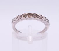 An unmarked white gold ten-stone diamond ring. Ring size K/L.