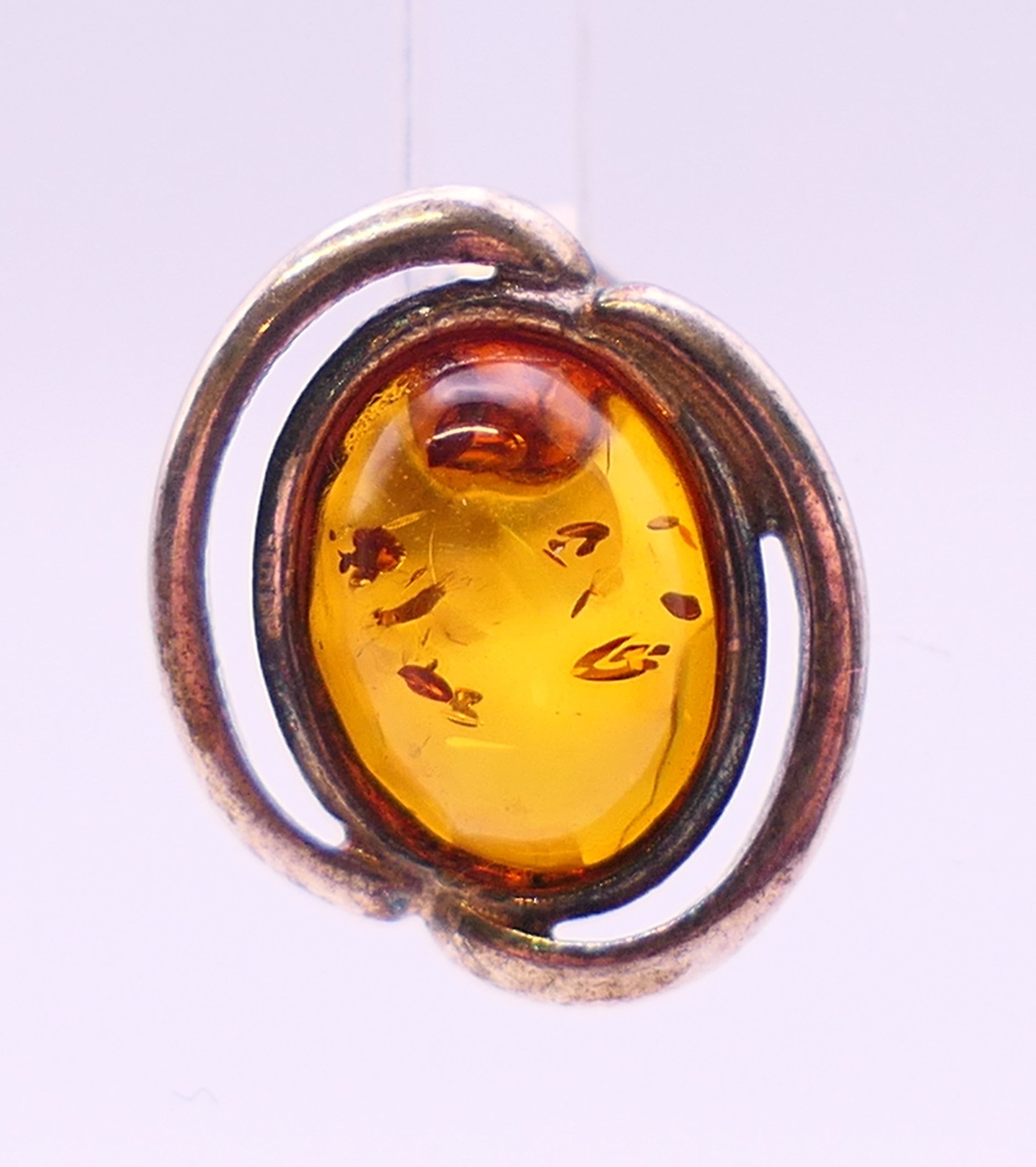 Four silver and amber items of jewellery. The largest pendant 5 cm high. - Image 10 of 11