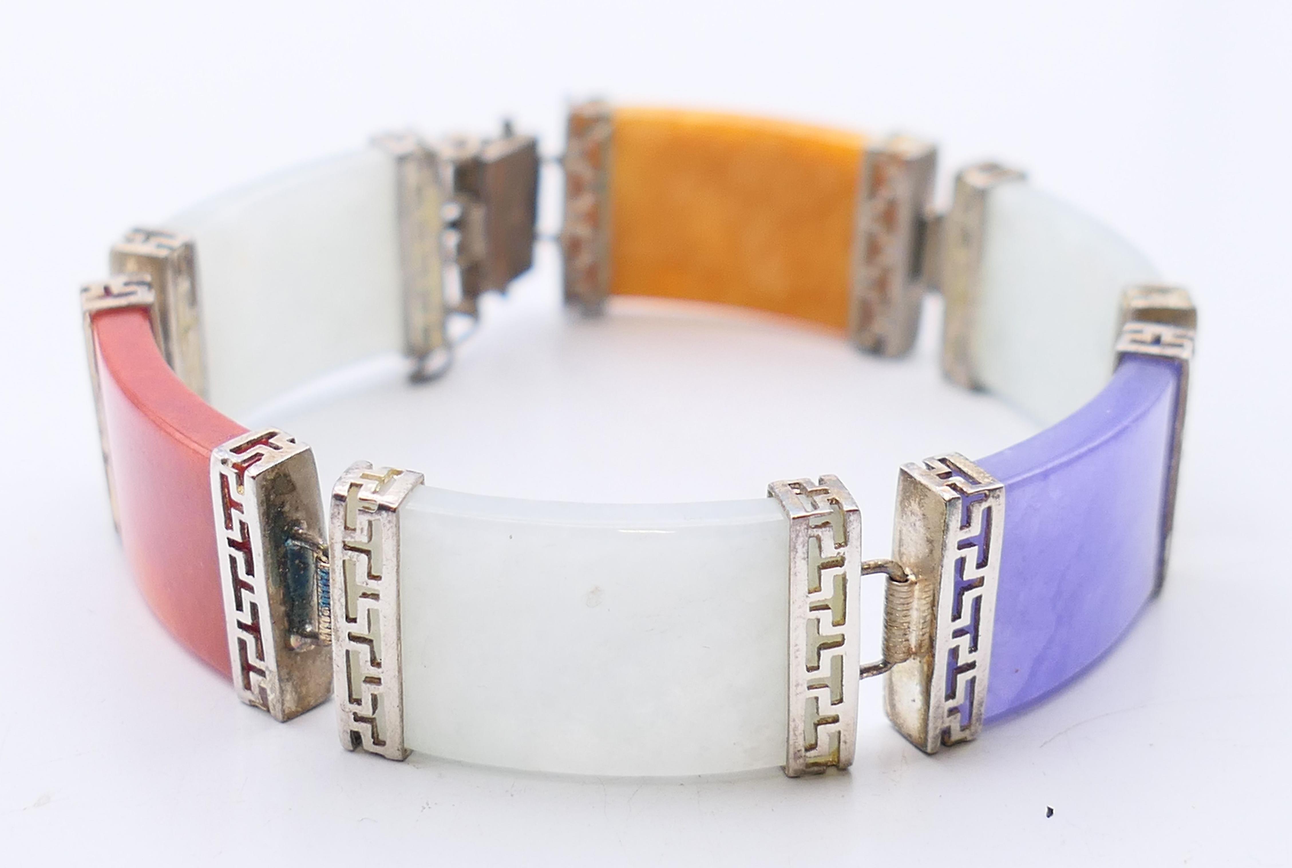 A Chinese multi-coloured jade bracelet set in silver. 18 cm long.