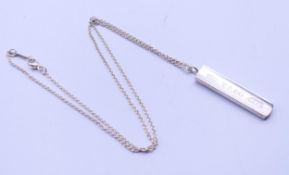 A boxed Tiffany & Co silver pendant on chain. The pendant 3.5 cm long.