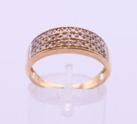 A 9 ct gold three row diamond ring. Ring size O/P.
