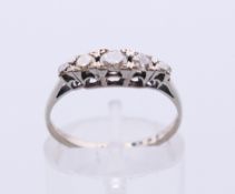 An 18 ct white gold diamond five-stone ring. Ring size K/L.