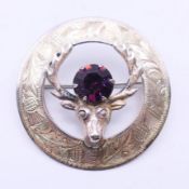 A silver stag's head brooch, hallmarked for Edinburgh. 4 cm diameter.