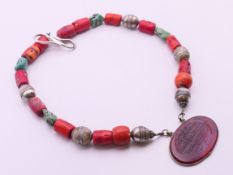 A silver, coral and turquoise pendant necklace. 48 cm long.