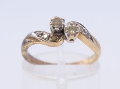 A 9 K gold diamond crossover ring. Ring size L.