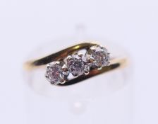 A 9 ct gold three-stone diamond ring. Ring size J/K.