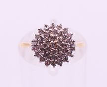 A 9 ct gold and diamond cluster ring. Ring size I/J.
