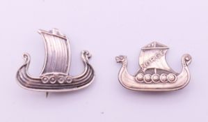 Two Norwegian silver brooches formed as Viking boats. The largest 3 cm long.
