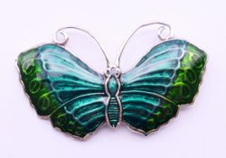 A silver butterfly brooch. 5 cm wide.
