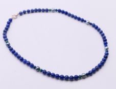 A silver, lapis lazuli and pearl necklace. 42 cm long.