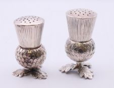 Two Georgian screw top thistle pepper pots, the largest marked for Birmingham 1835, maker's mark JW.