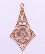 A small unmarked gold pendant. 3.2 cm high. 1.4 grammes.