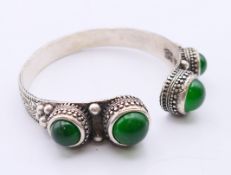 A Chinese white metal bangle. 6 cm inner diameter.