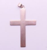 A silver cross pendant. 6 cm high.