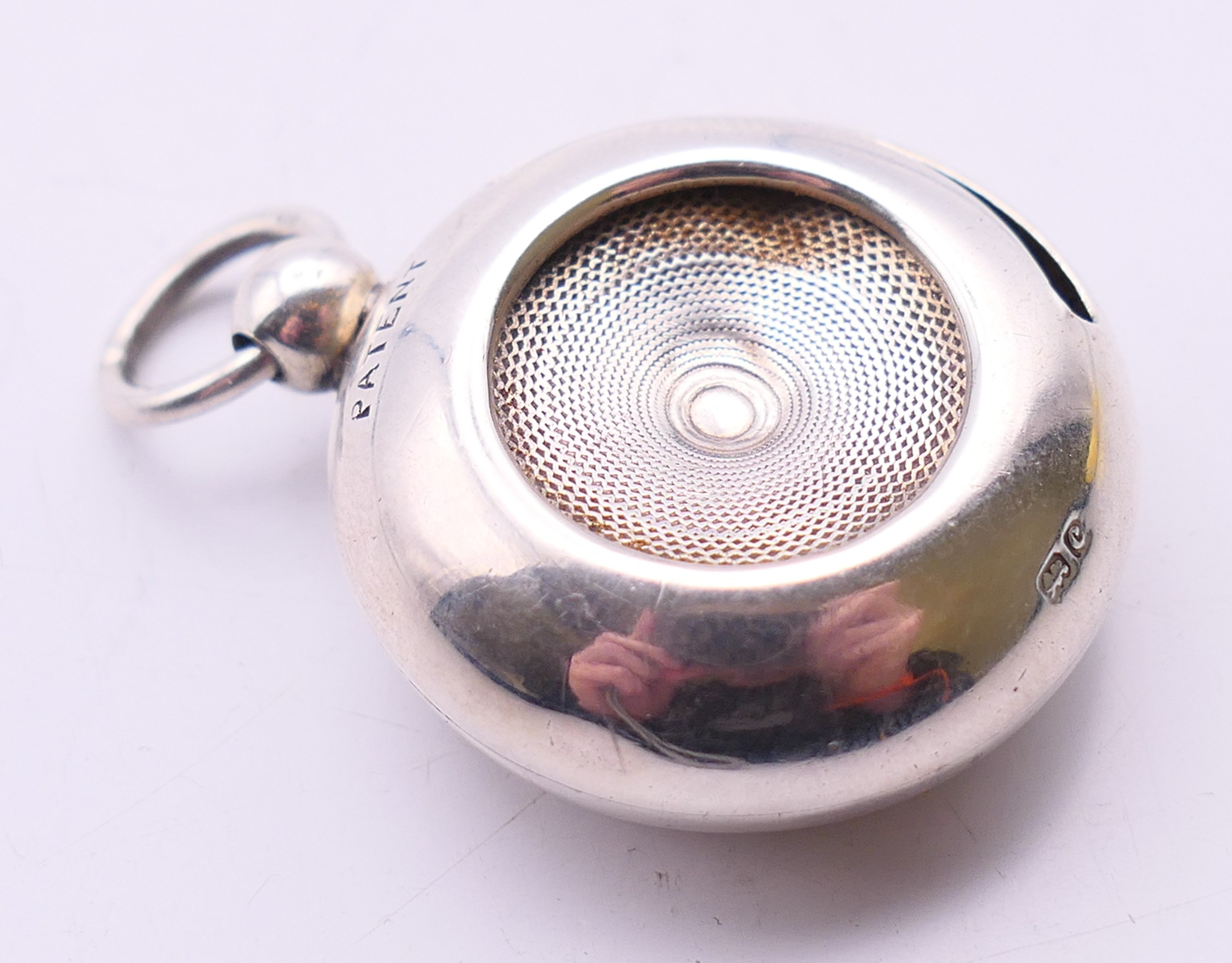 A silver sovereign holder. 3 cm diameter.